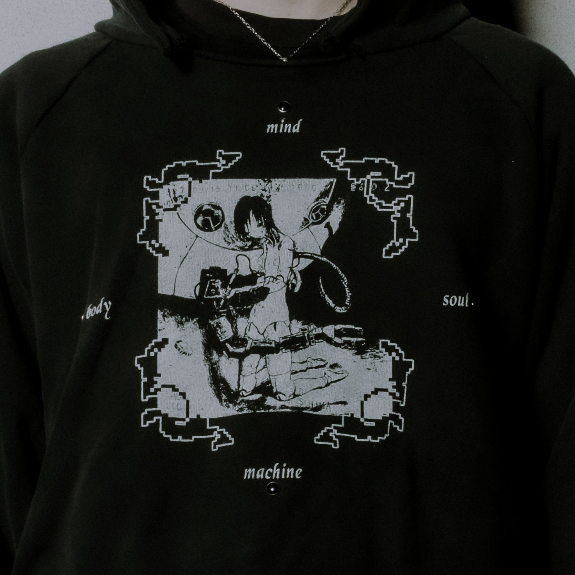 Black hoodie with a graphic design of a person sitting in a chair, labeled 'mind', 'body', 'soul', and 'machine'.